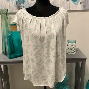 Green and white patterned blouse with boat neck